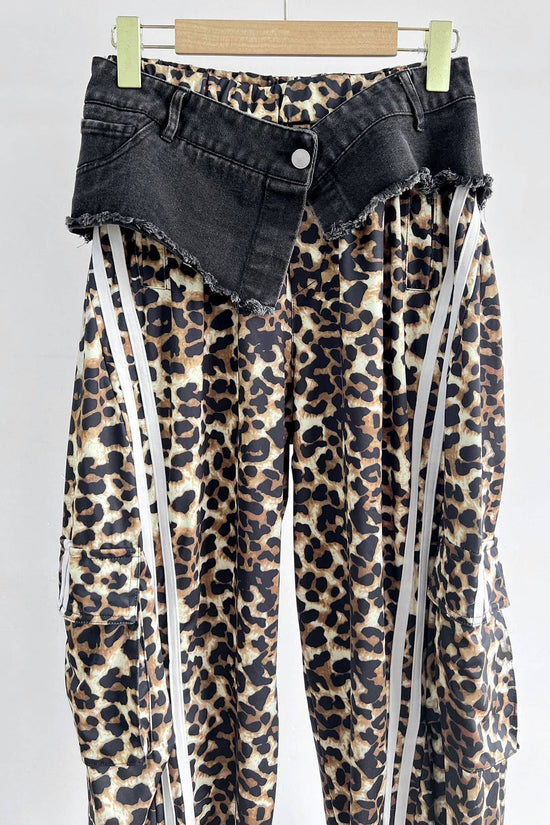 Leopard print pants with black denim waistband on a white background Born To Glam
