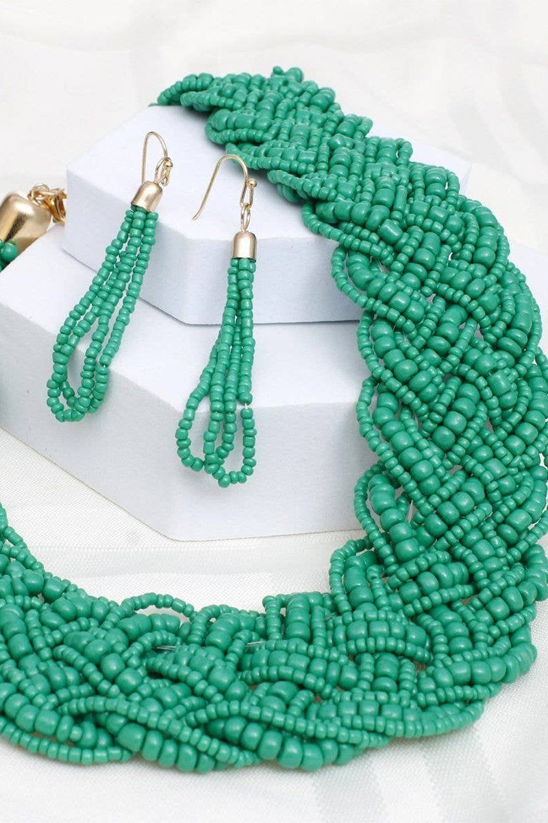 Green beaded necklace and earrings on a white background Born To Glam