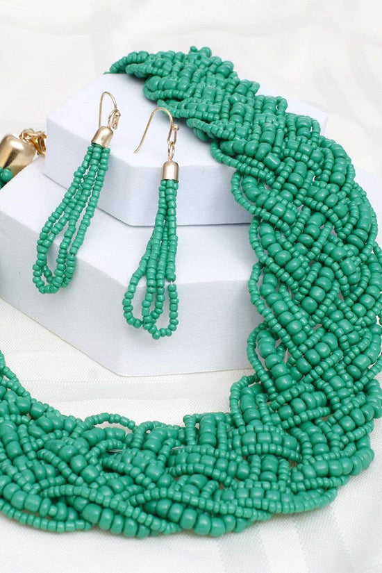 Green beaded necklace and earrings on a white background Born To Glam