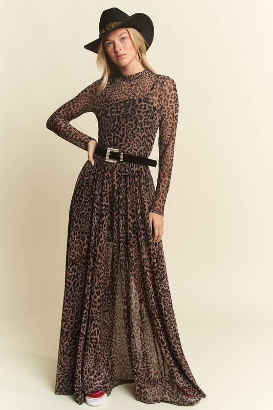 Woman wearing a long leopard print dress with a black belt and hat on a beige background Born To Glam