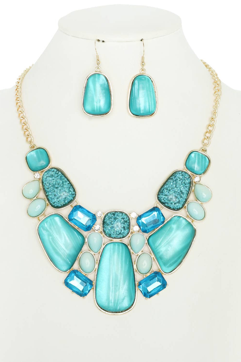 Turquoise necklace and earrings set on a mannequin bust with a white background Born To Glam