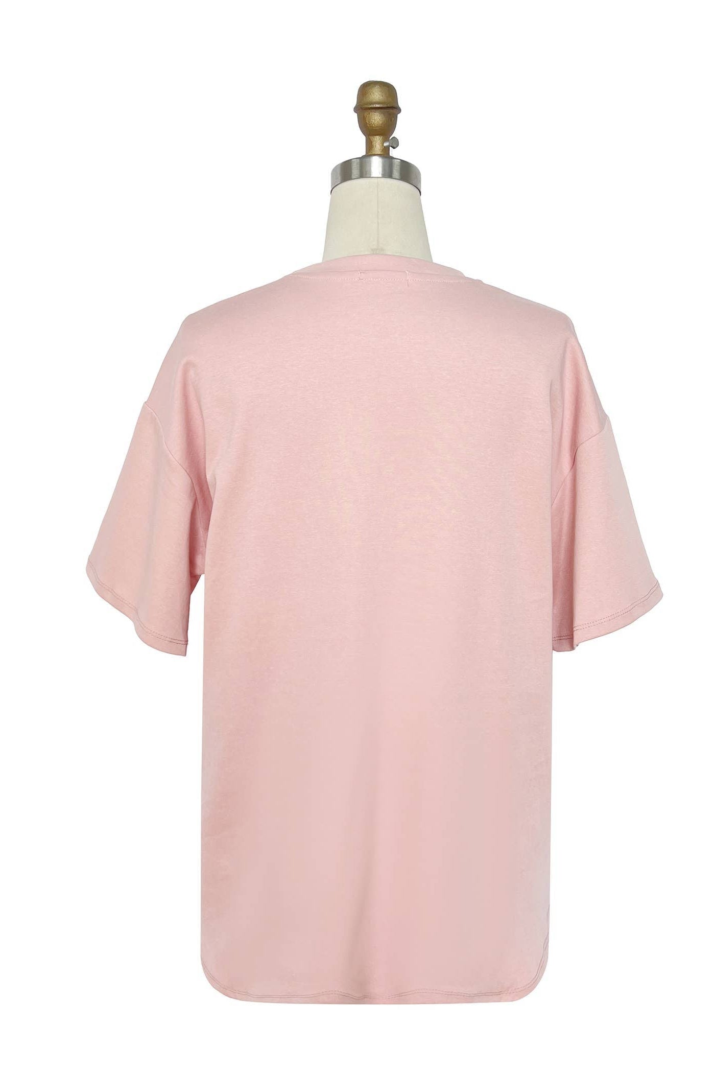 Pink t-shirt on a mannequin against a white background Born To Glam