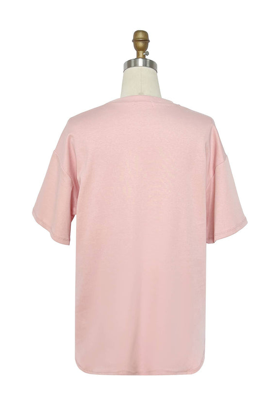 Pink t-shirt on a mannequin against a white background Born To Glam