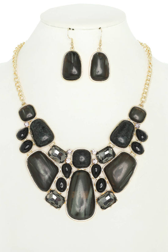 Black stone necklace and earrings set on a mannequin with a white background Born To Glam