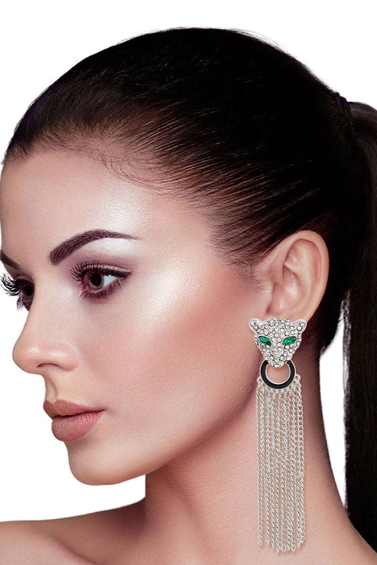 Woman wearing a cat-shaped earring with tassels on a white background Born To Glam