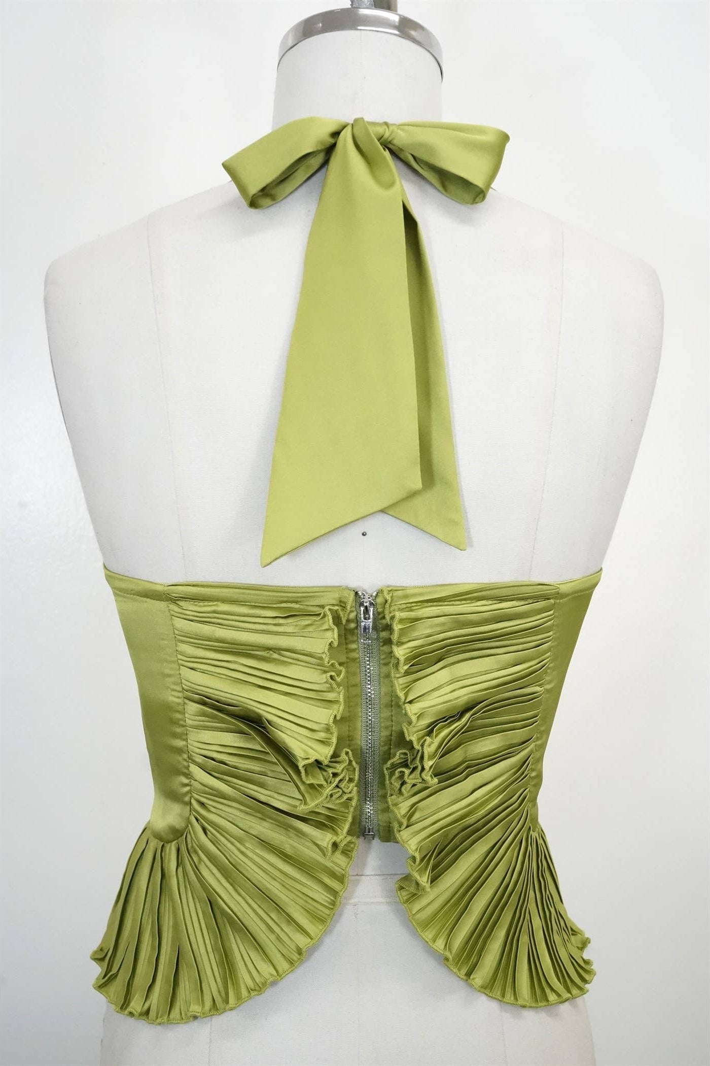 Green halter top with ruched design on a mannequin against a white background Born To Glam