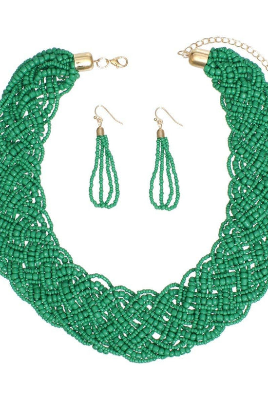 Green beaded necklace and earrings set on a white background Born To Glam