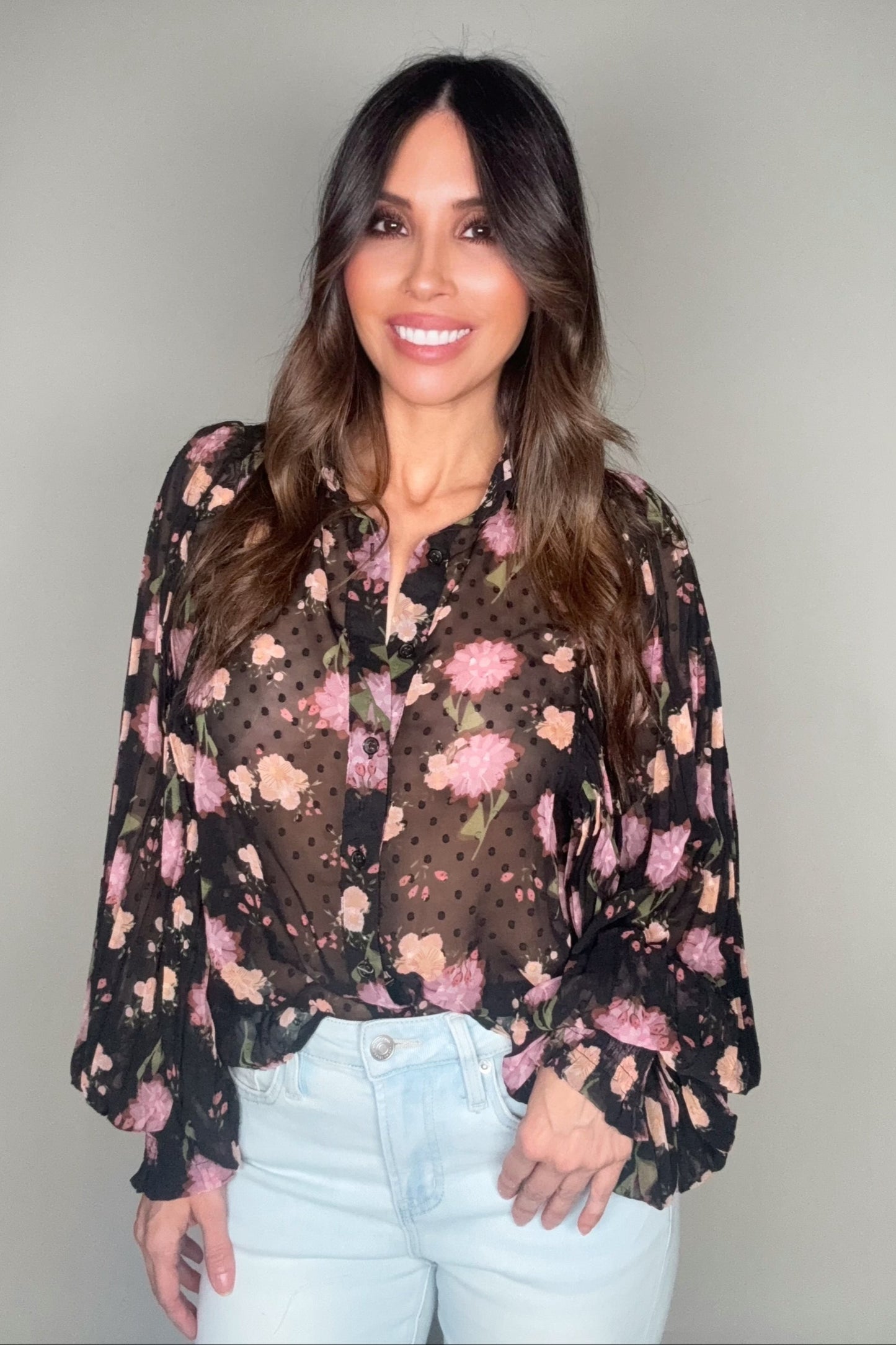 Woman wearing a floral blouse with a plain background Born To Glam