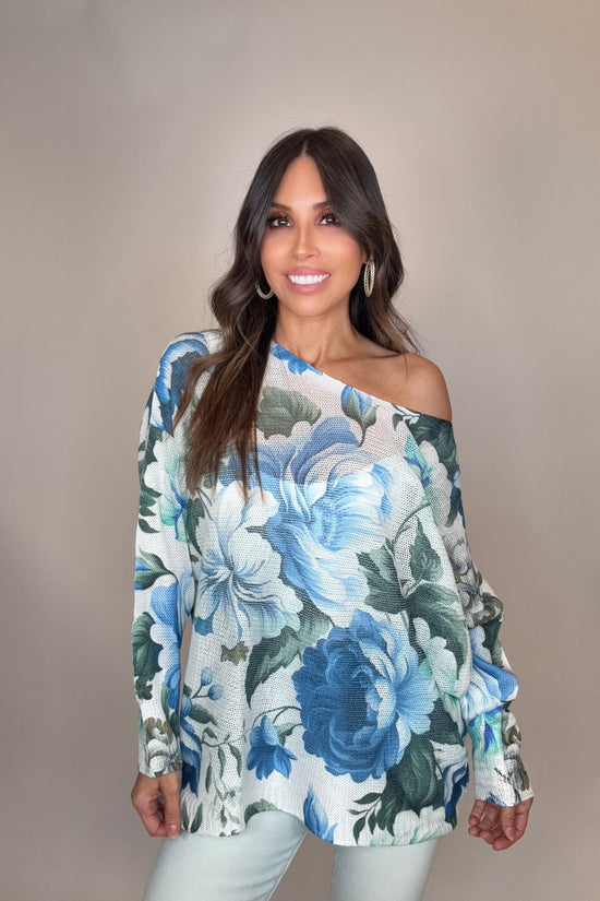 Woman wearing a floral off-shoulder top against a plain background Born To Glam