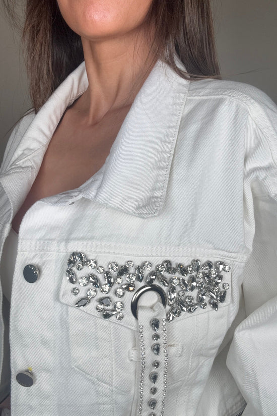 Close-up of a white denim jacket with decorative elements. Born To Glam