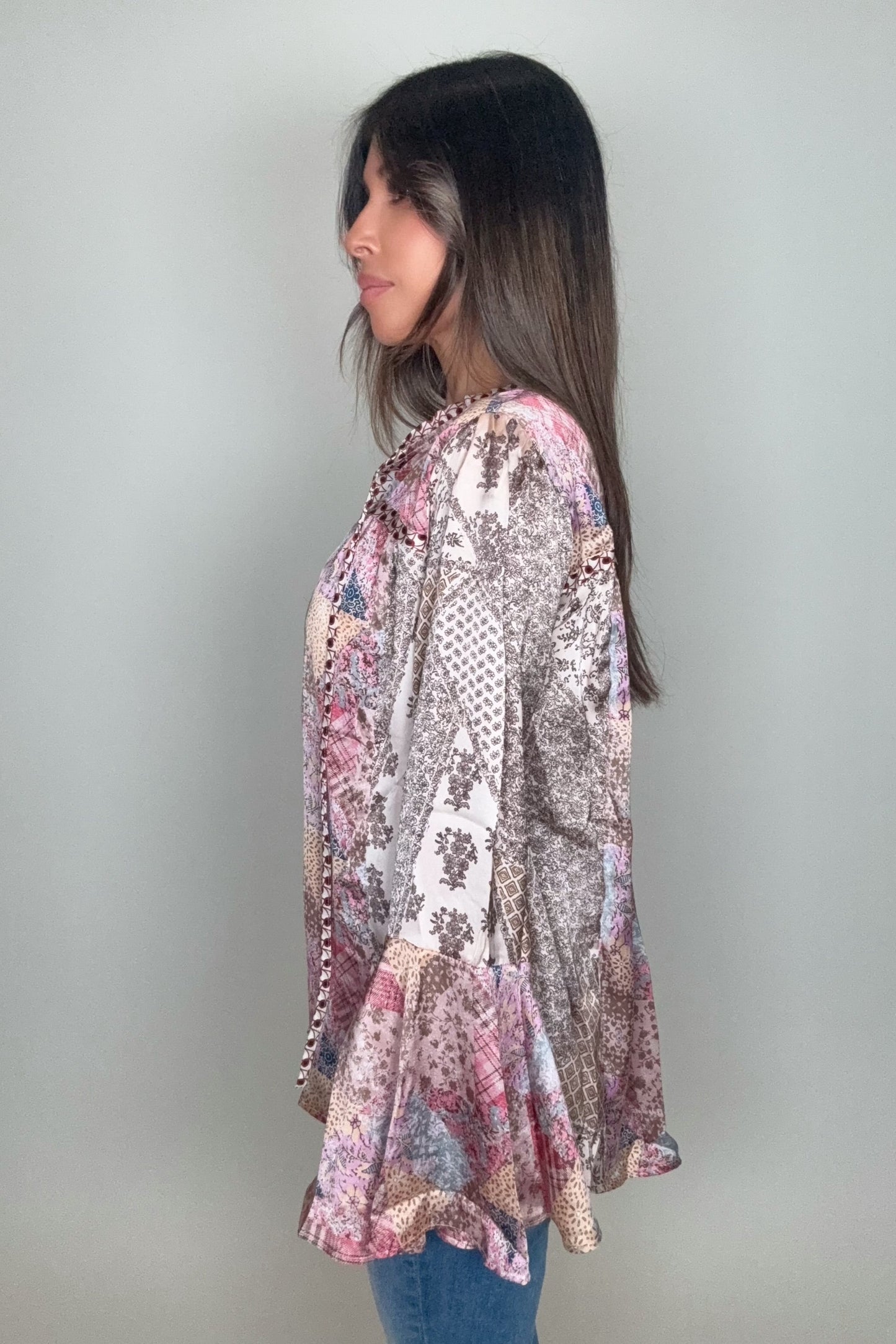 Woman wearing a patterned long-sleeve top against a plain background Born To Glam