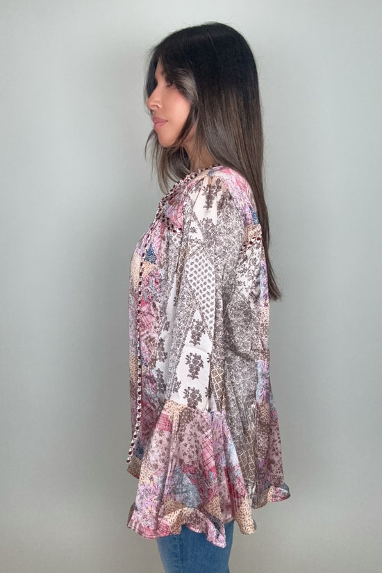 Woman wearing a patterned long-sleeve top against a plain background Born To Glam