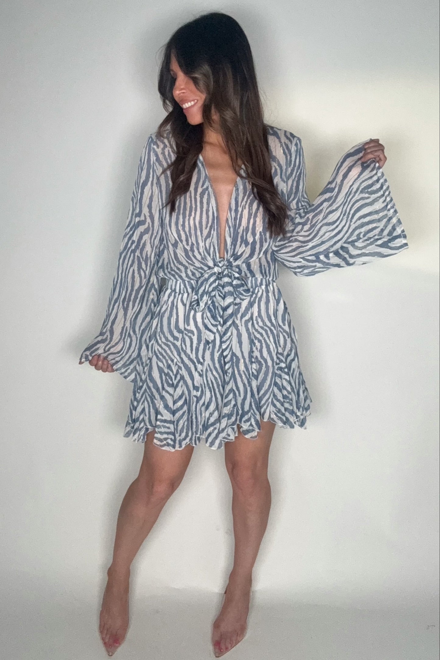 Woman wearing a patterned dress against a plain background Born To Glam