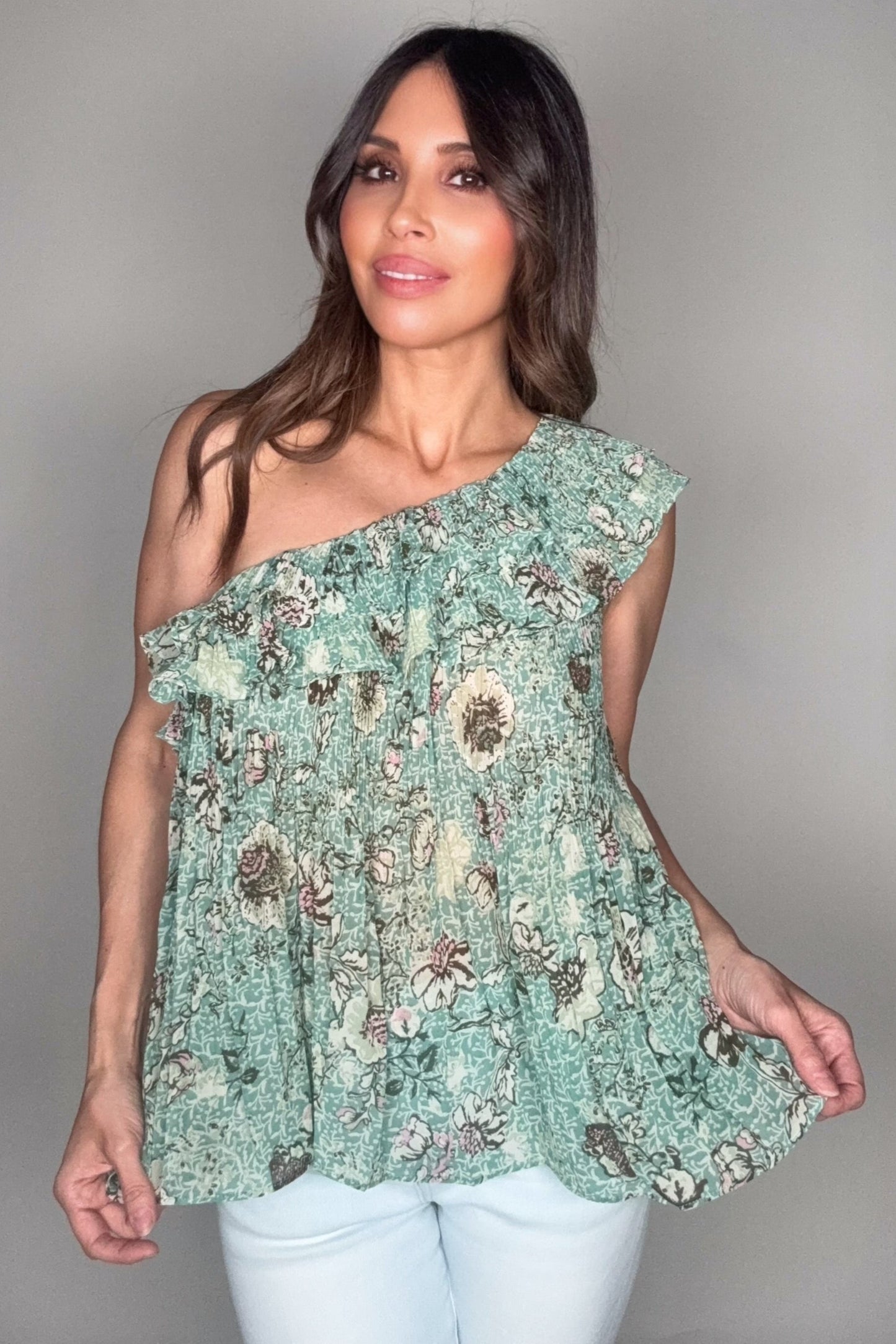 Woman wearing a floral one-shoulder top against a plain background Born To Glam