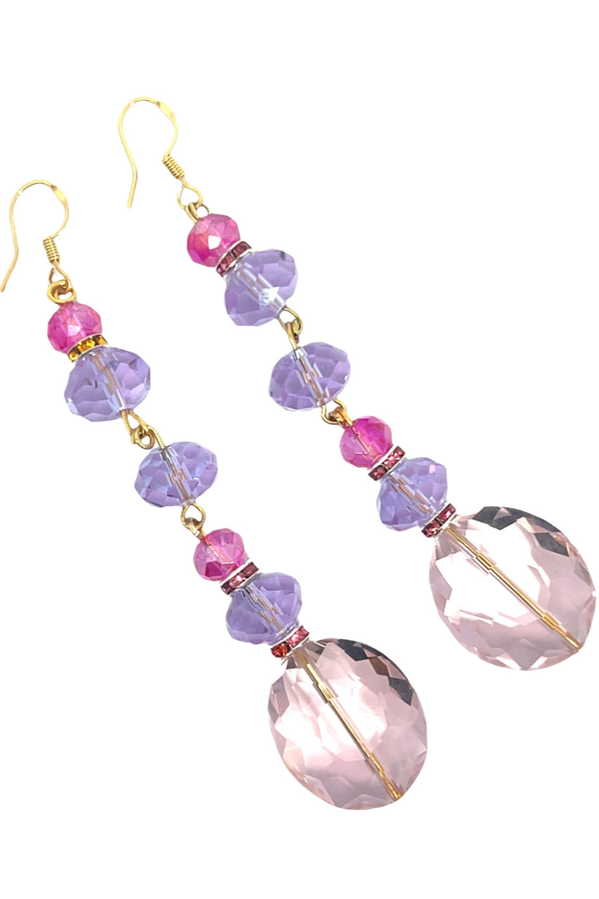 Pair of earrings with pink and purple beads on a white background Born To Glam