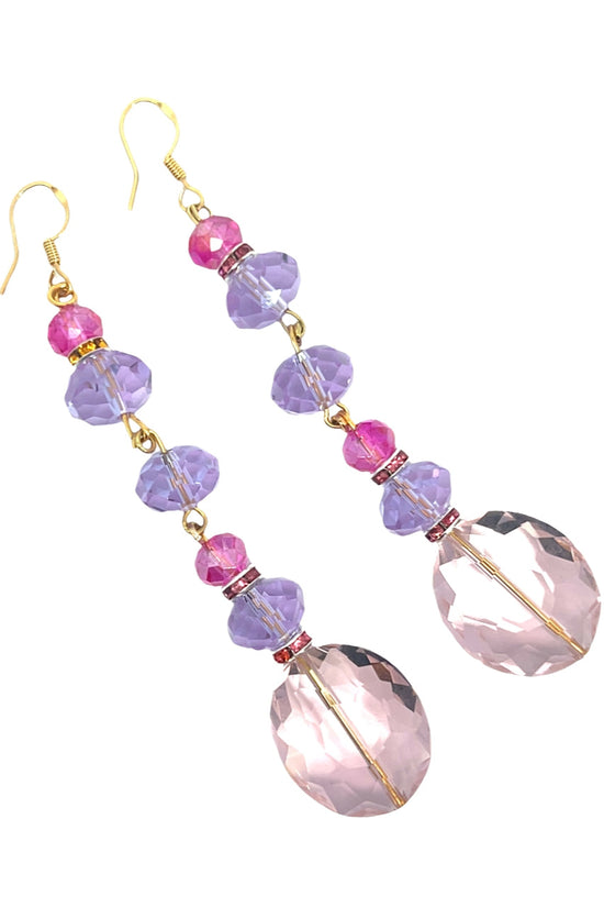 Pair of earrings with pink and purple beads on a white background Born To Glam
