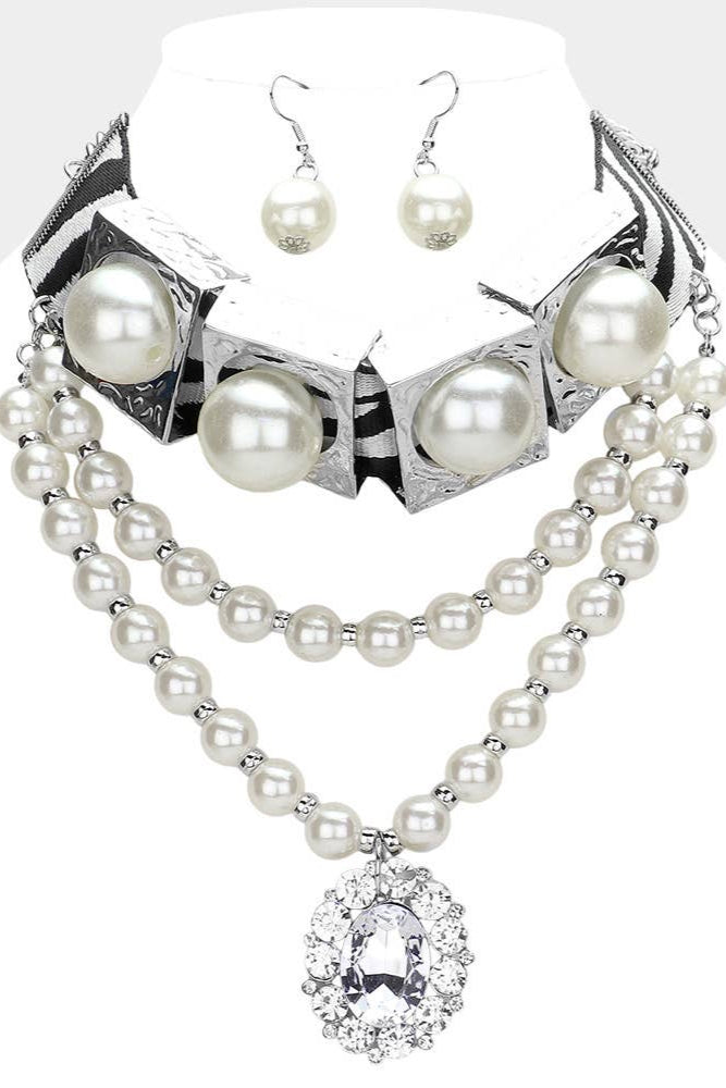 Pearl necklace and earrings set on a mannequin with a white background Born To Glam