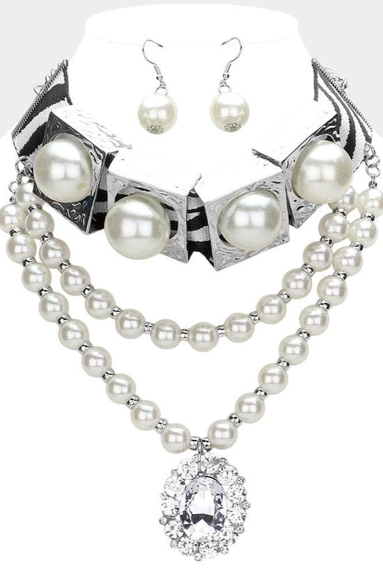Pearl necklace and earrings set on a mannequin with a white background Born To Glam