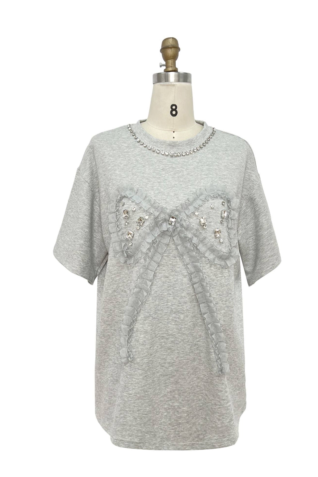 Gray sweater with embellishments on a mannequin against a white background Born To Glam