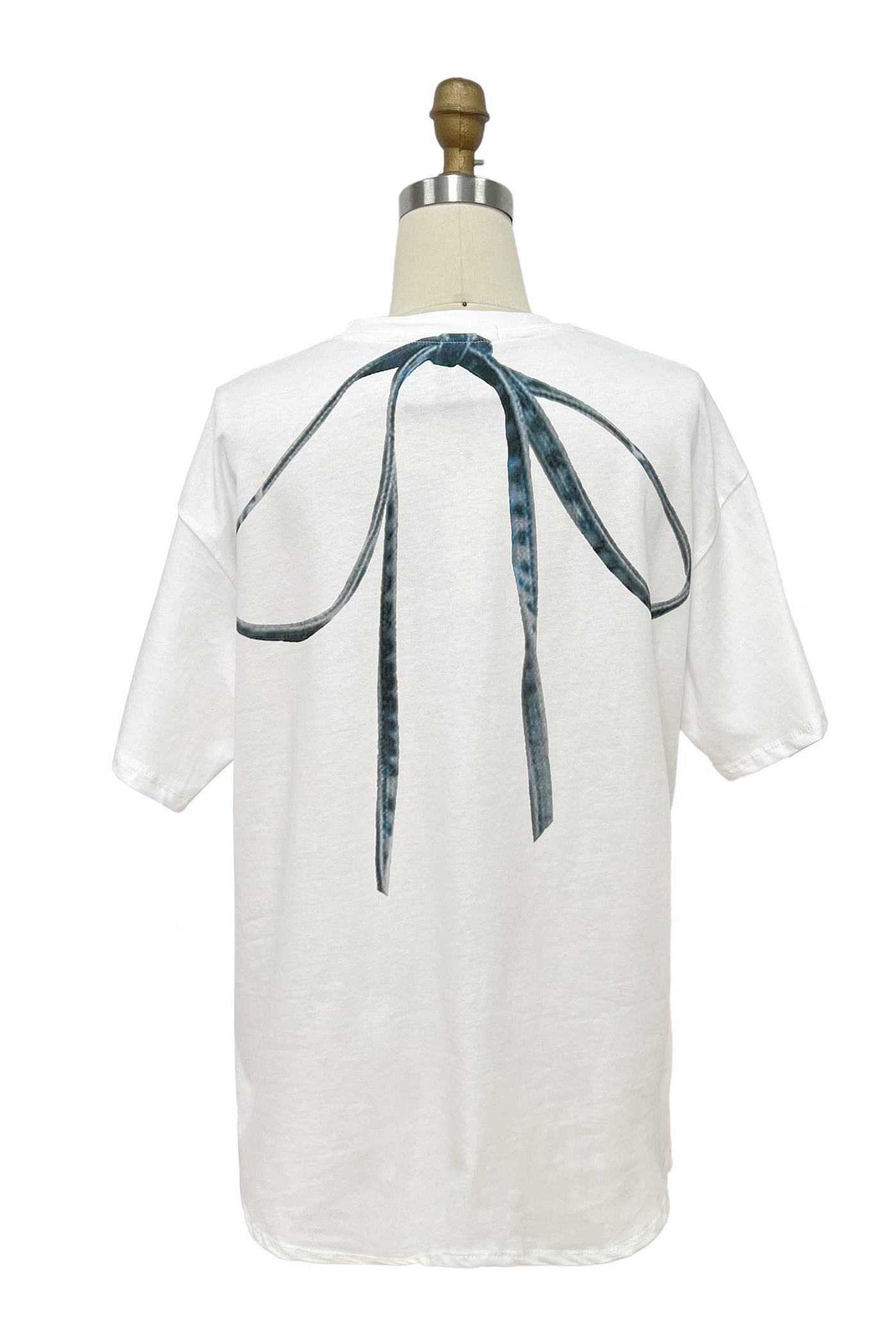 White blouse with a blue ribbon on a mannequin against a white background Born To Glam