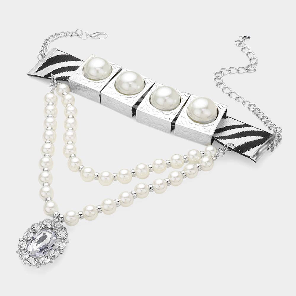Pearl necklace with a silver clasp on a white background Born To Glam