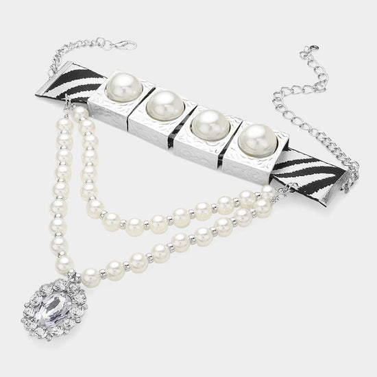 Pearl necklace with a silver clasp on a white background Born To Glam