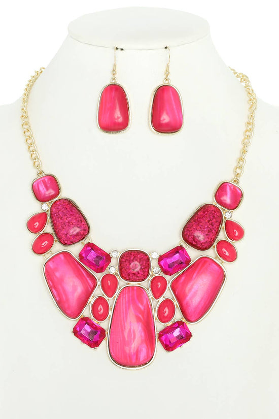 Necklace and earrings set with pink stones on a white background Born To Glam