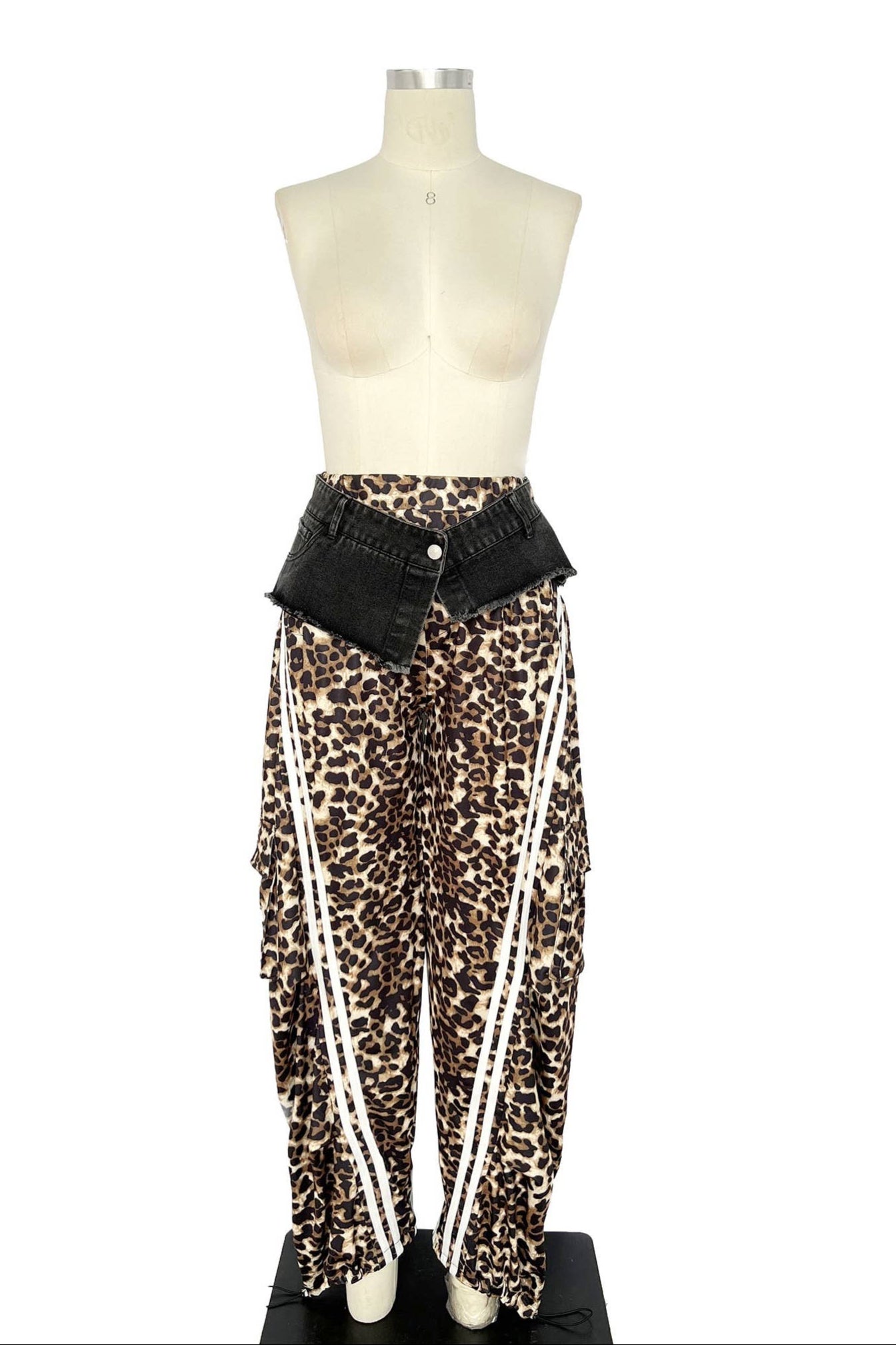 Mannequin wearing leopard print pants with a black belt on a white background Born To Glam