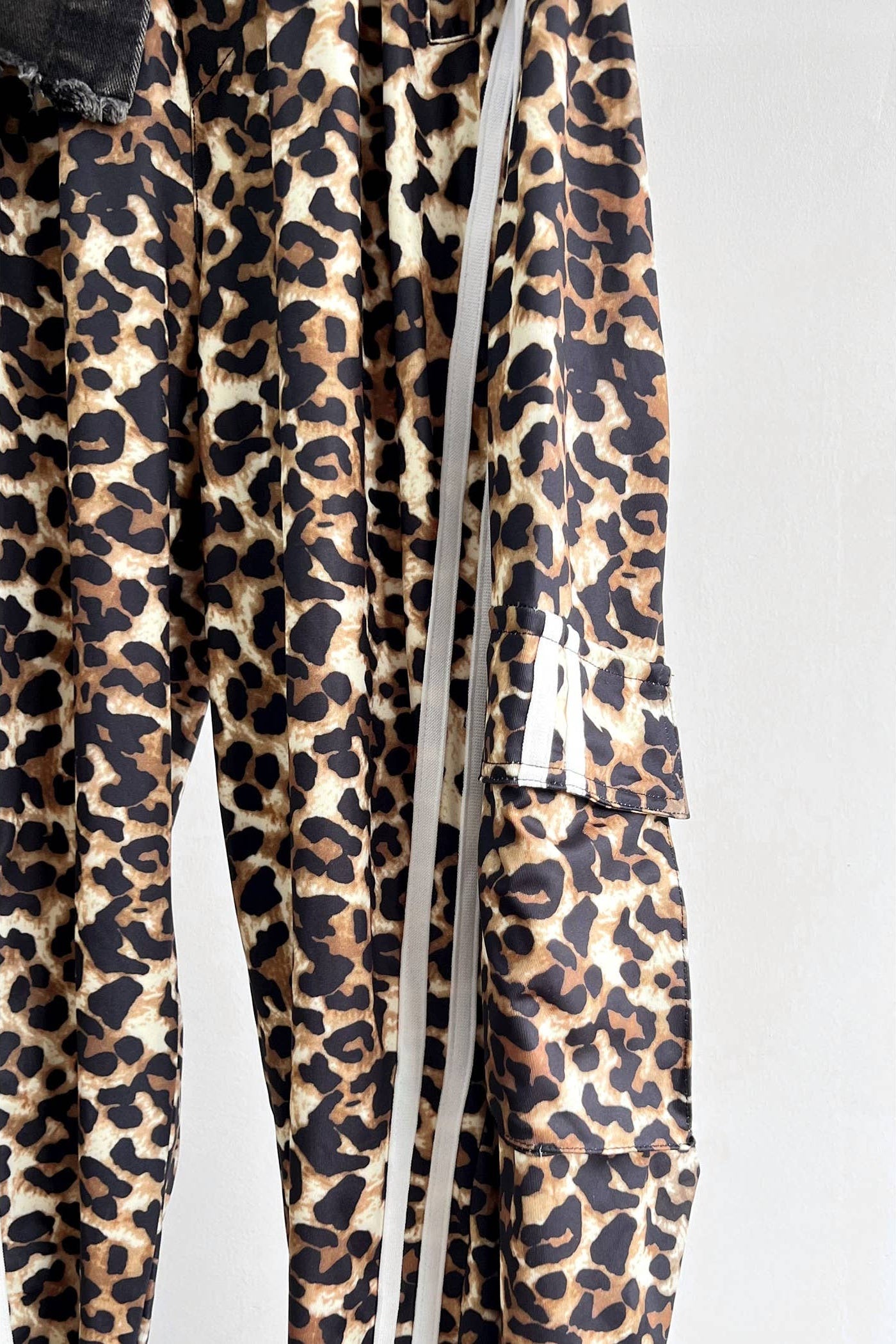 Leopard print pants with white drawstrings on a light gray background Born To Glam